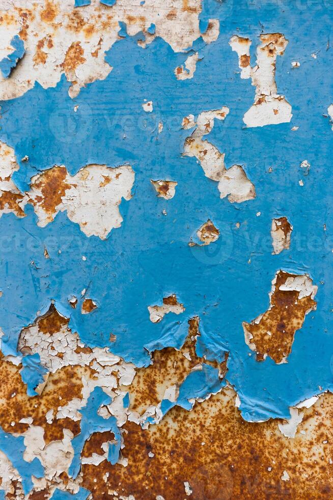 rusty metal surface with blue paint flaking and cracking texture photo