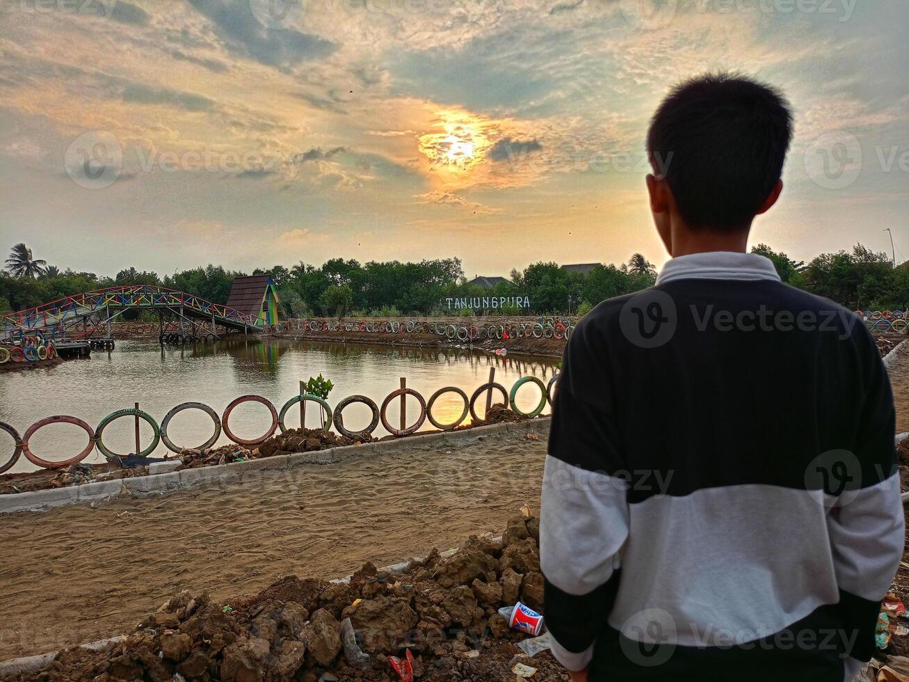A boy on a mangrove beach in the afternoon photo