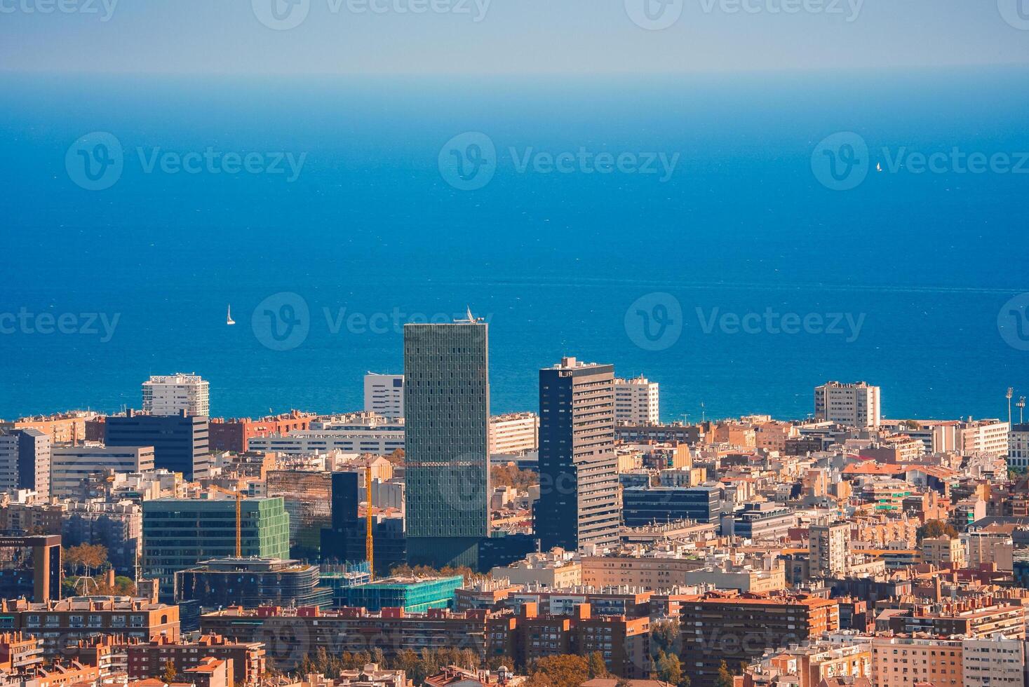 Panoramic View of Barcelona's Cityscape and Mediterranean Coastline photo