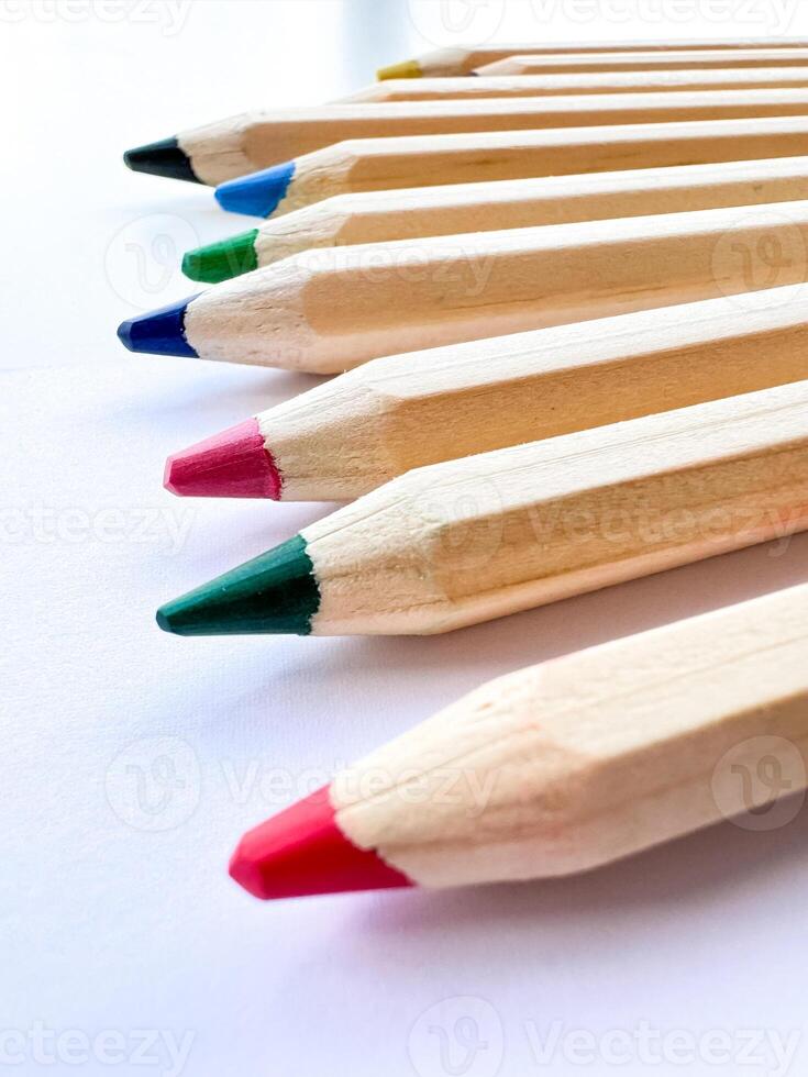 Wooden colorful ordinary pencils isolated on a white background photo