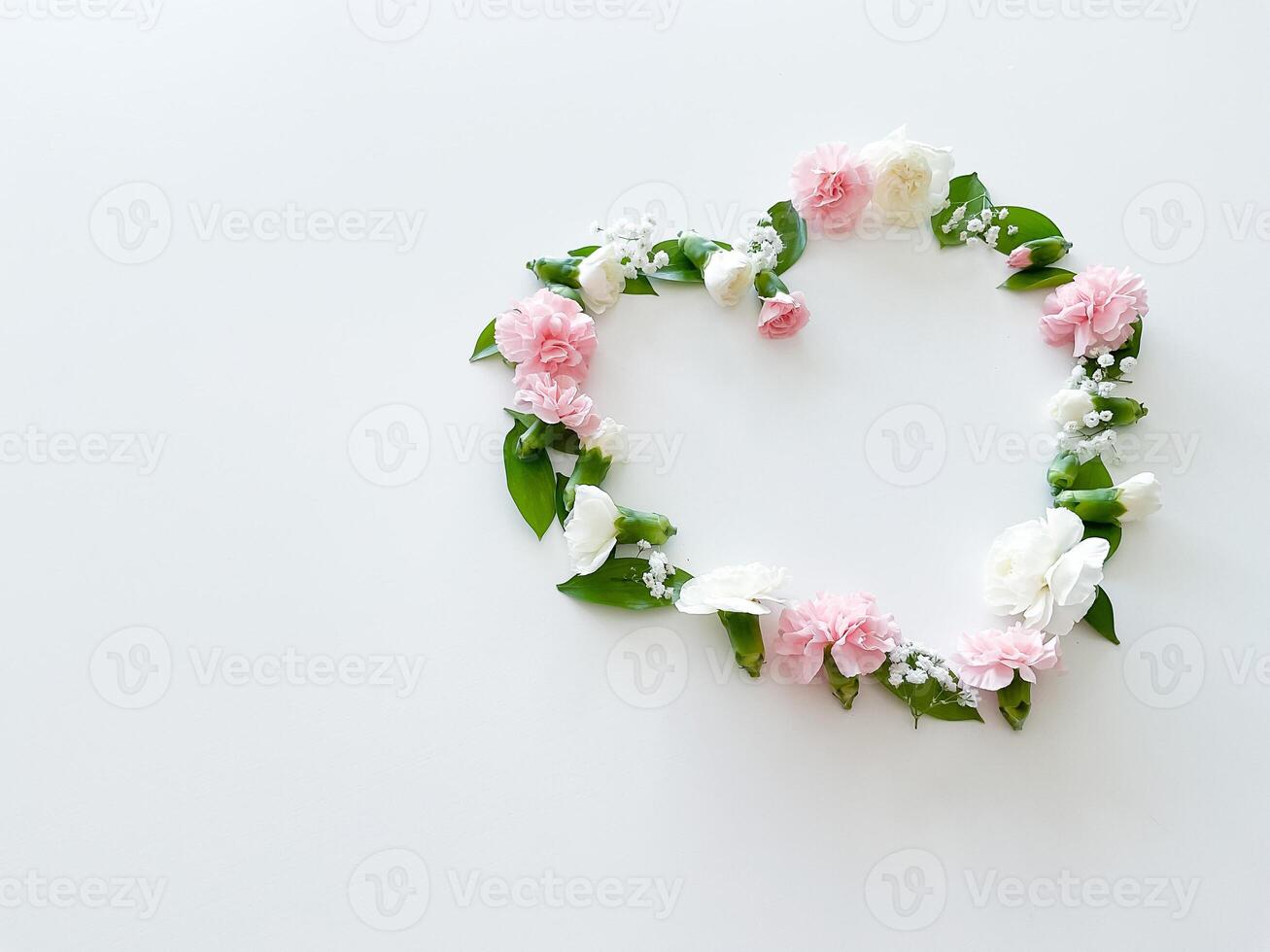 Frame in form of heart from pink, white carnations photo