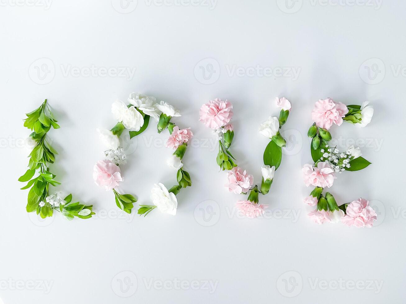 The word LOVE from flowers on a white background photo