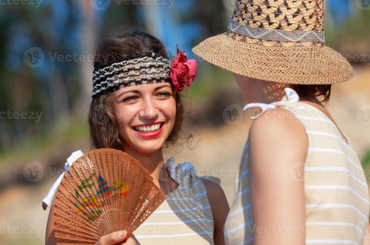 Two young women in retro swimsuits by the sea photo