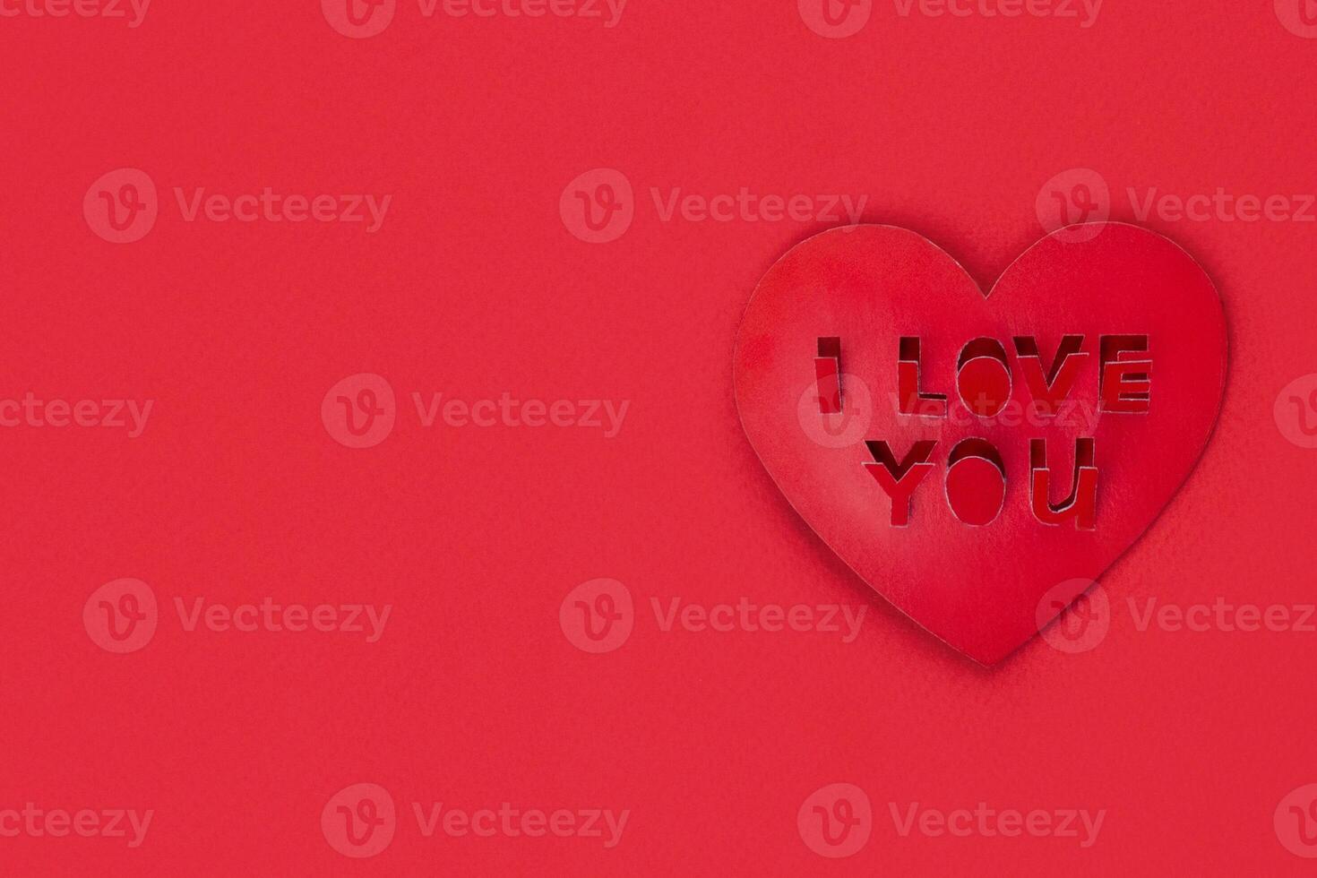 Valentine card, Inscription I love you, red heart shape on red background copy space photo