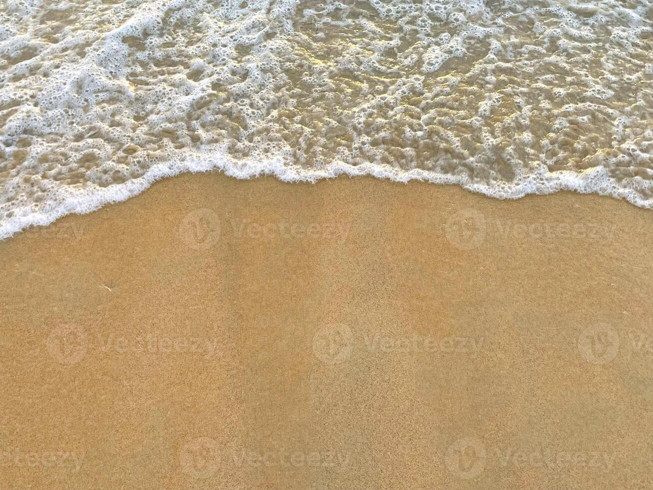 sunny Small, Soft wave on sand beach, text copy space for banners, cards. Close up top view of sea blue waves break on sand. photo was shot in evening at sunset