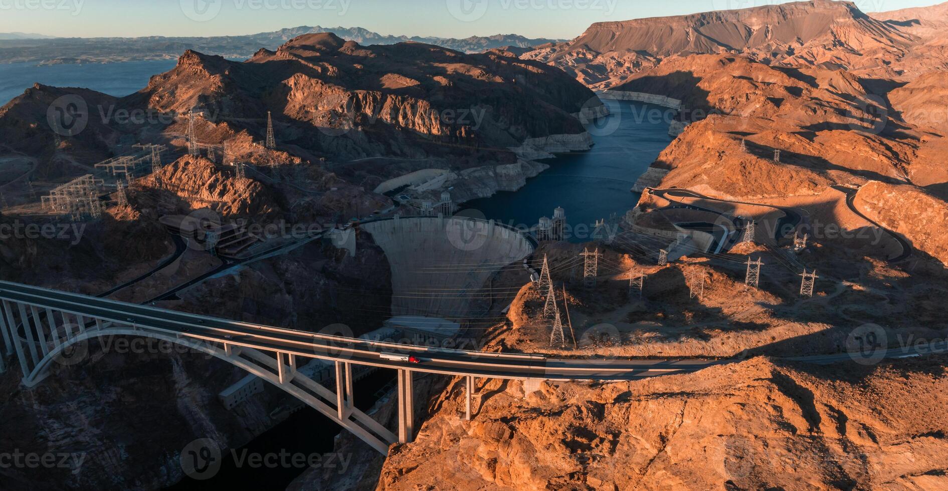 Hoover Dam on the Colorado River straddling Nevada and Arizona at dawn from above. photo