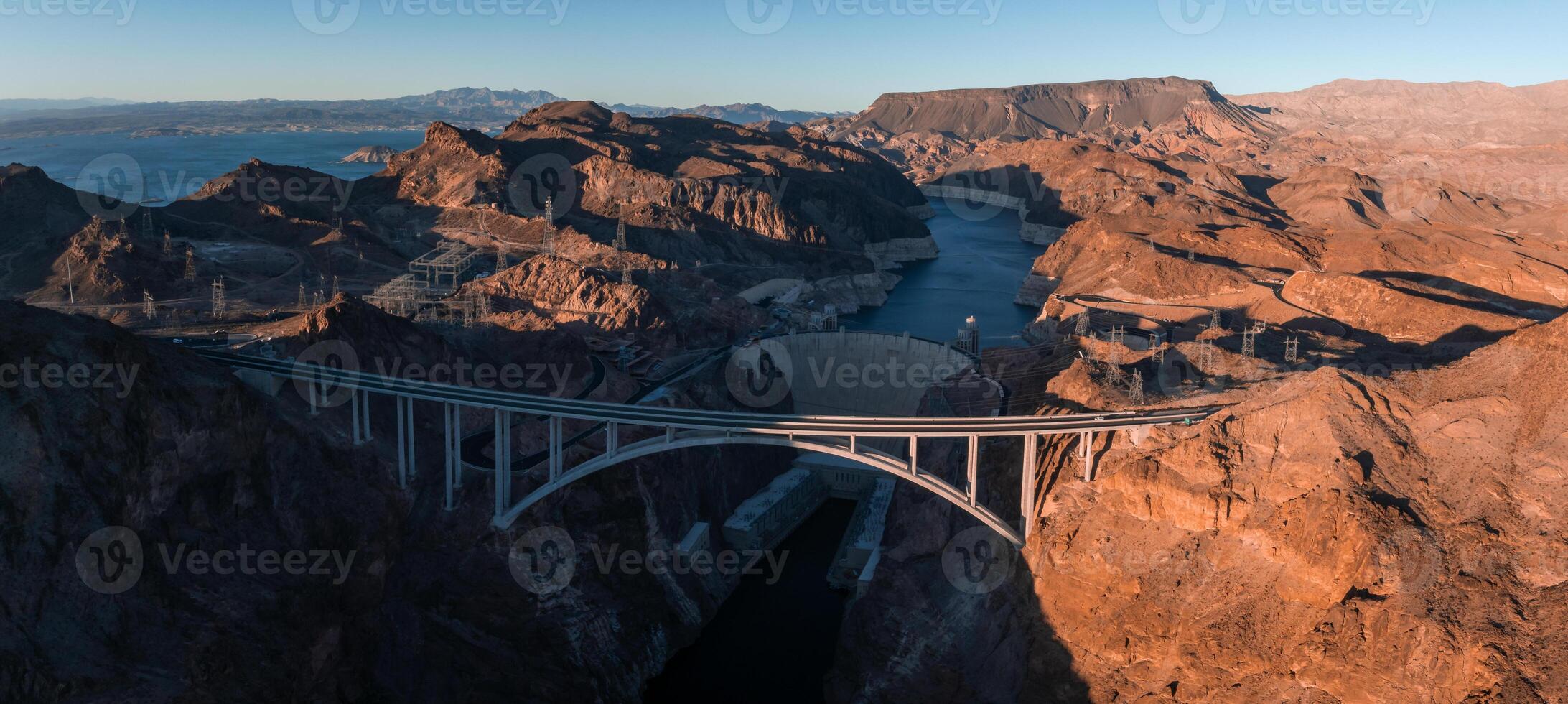 Hoover Dam on the Colorado River straddling Nevada and Arizona at dawn from above. photo