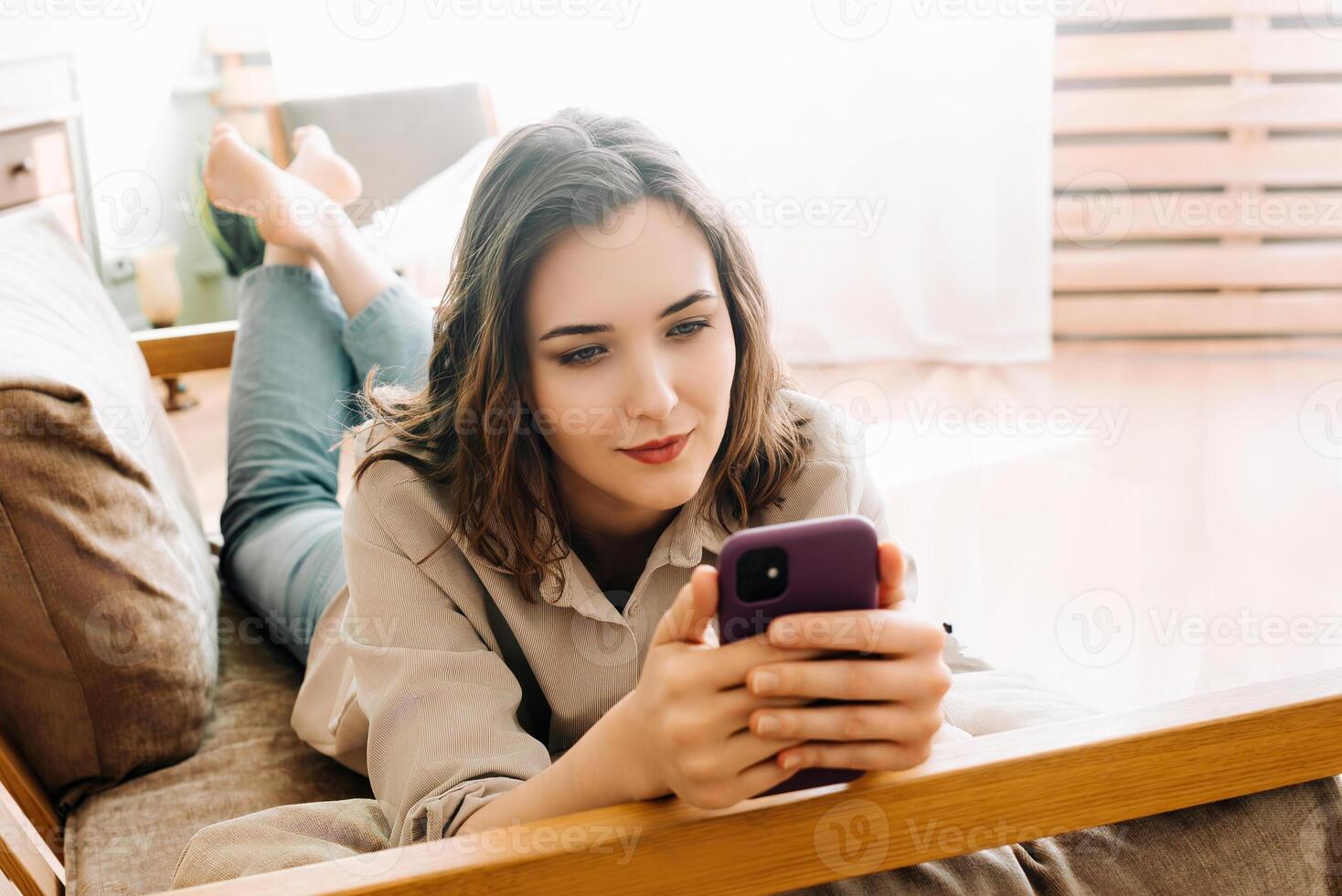 Digital Connection. Smiling Young Woman Engaged in Smartphone Typing, Social Network Chatting, and Internet Surfing. Modern Communication and Social Media Lifestyle Concept photo