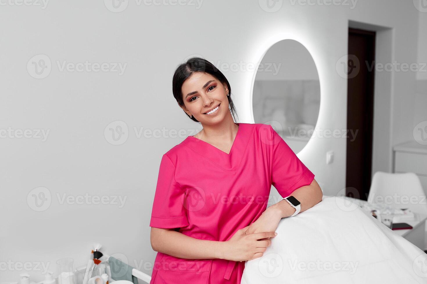 Beautiful doctor cosmetologist in a private office photo