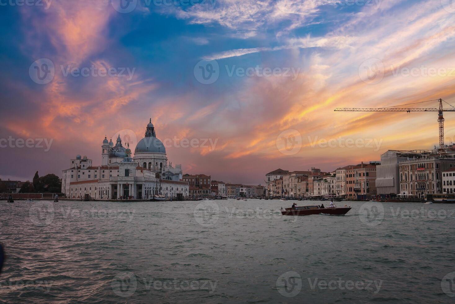 Moody Venice cityscape with boat in the water on a cloudy day in Italy. photo