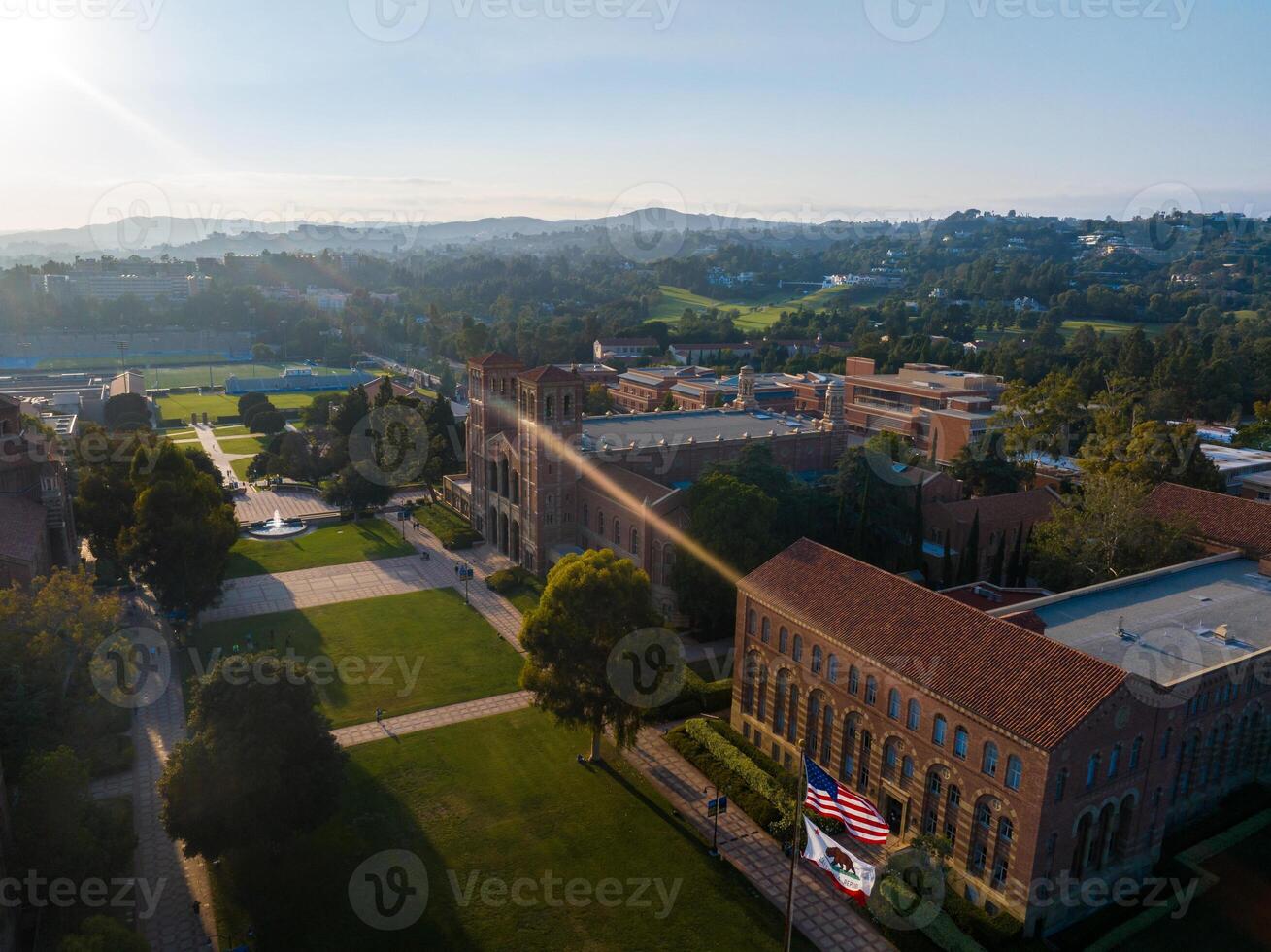 aéreo ver de americano Universidad instalaciones a amanecer con clásico y moderno arquitectura, verde espacios foto