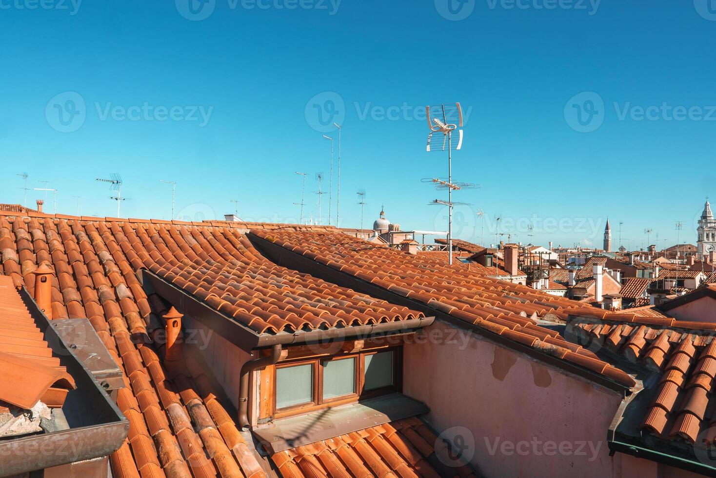 Tranquil Venice Serene rooftop view of the historic city with clear blue sky. photo