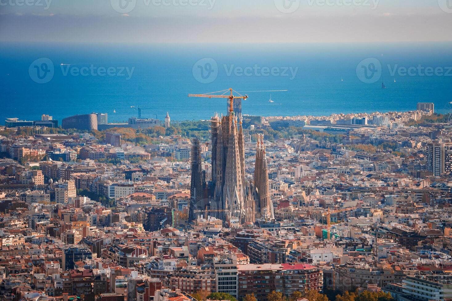 Expansive Panoramic View of Barcelona, Sagrada Familia, and the Sea Horizon photo