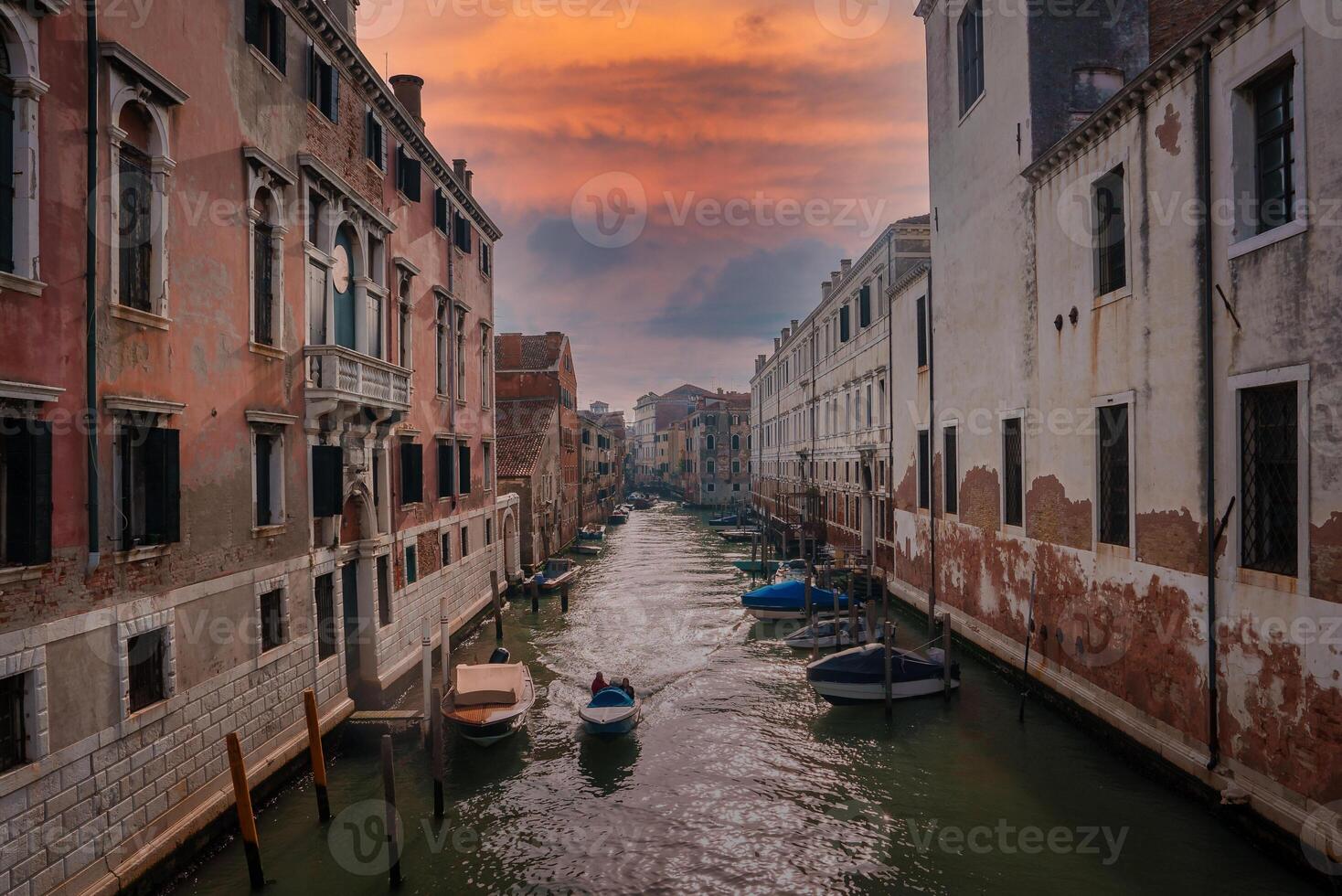 Sunlit Narrow Canal in Venice, Italy Serene and Tranquil Waterway in Unknown Location photo