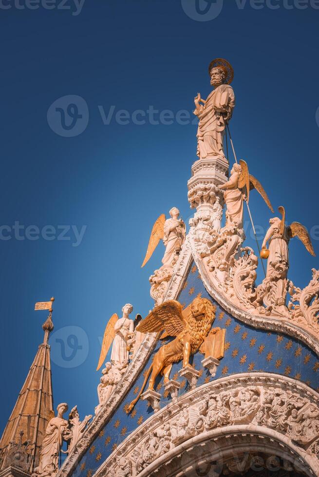 Ornate Renaissance-style building with angels and blue sky in Venice, Italy photo