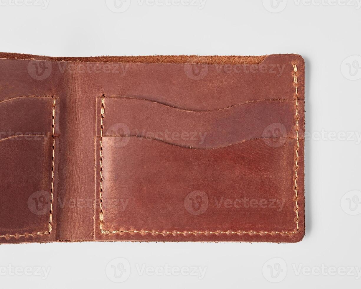 Open brown leather wallet with card pockets and hidden embossed message photo