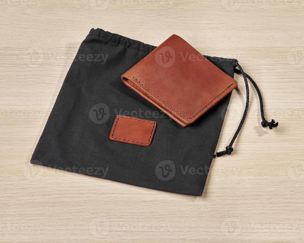 Custom brown leather wallet with embossed initials and fabric case photo