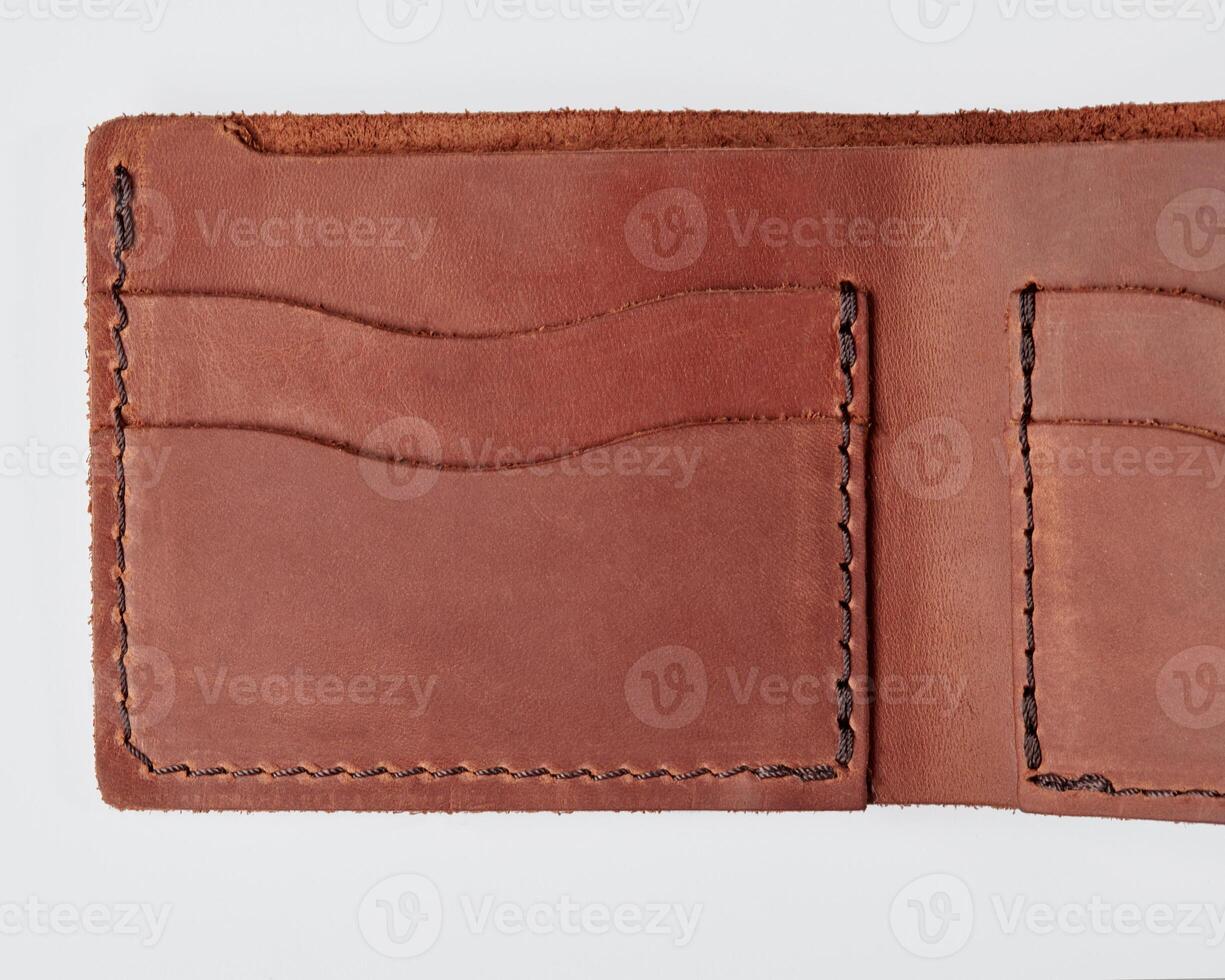 Open brown leather wallet with pockets for cards and drivers license photo