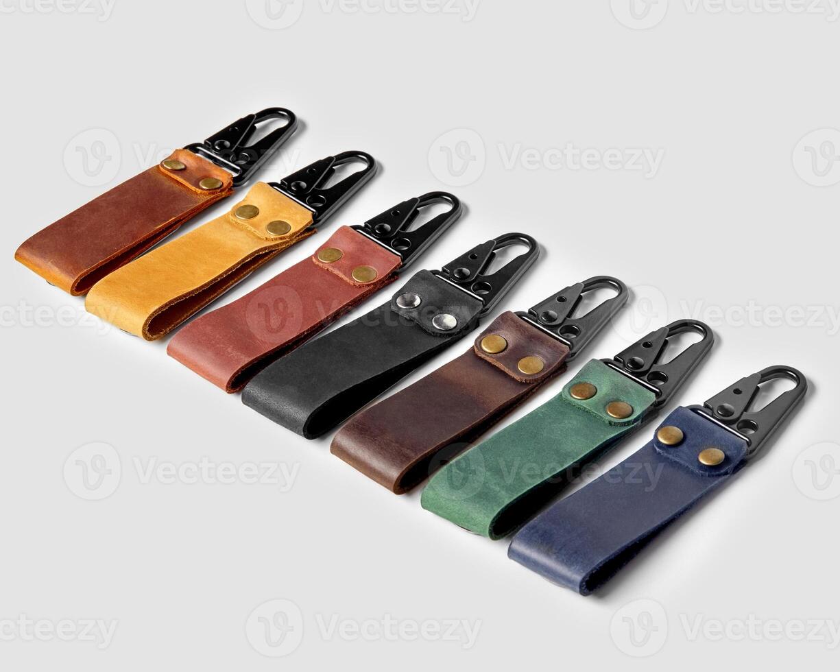 Handcrafted embossed leather keychains of various colors with carabiner clasps photo