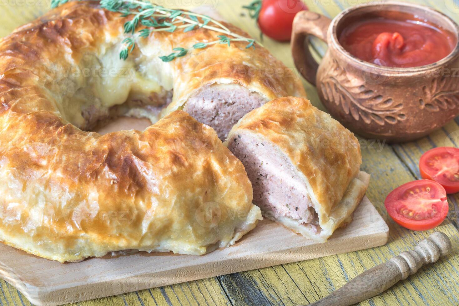 Meatball Wellington ring with tomato sauce photo