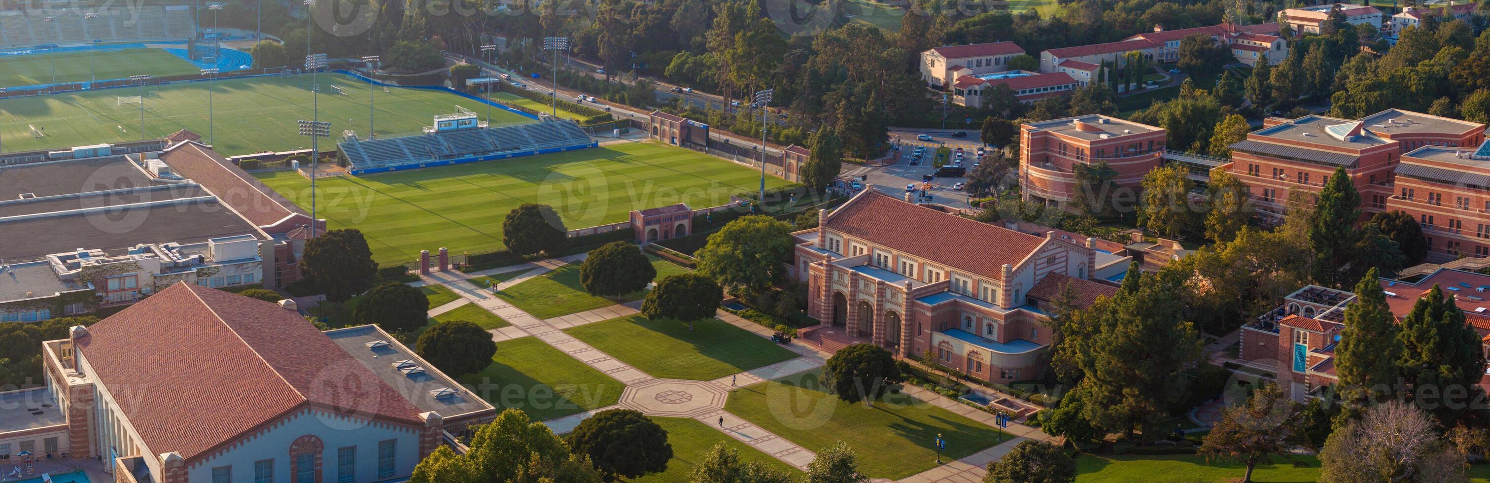 Aerial View of UCLA Campus with Traditional and Modern Architecture, Lush Greenery, and Sports Stadium photo