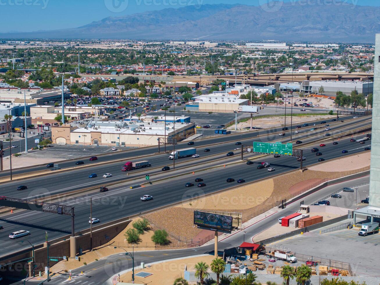 Aerial View of Southwestern Urban Landscape with Busy Highway and Suburban Homes Under Clear Blue Sky photo