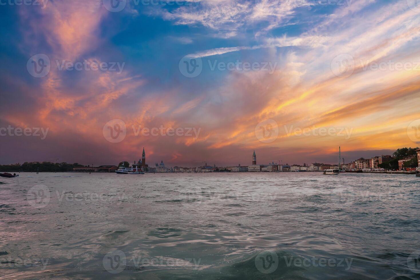 Iconic Venice Landmarks Moody View of Traditional and Modern Architecture from Boat on Water photo