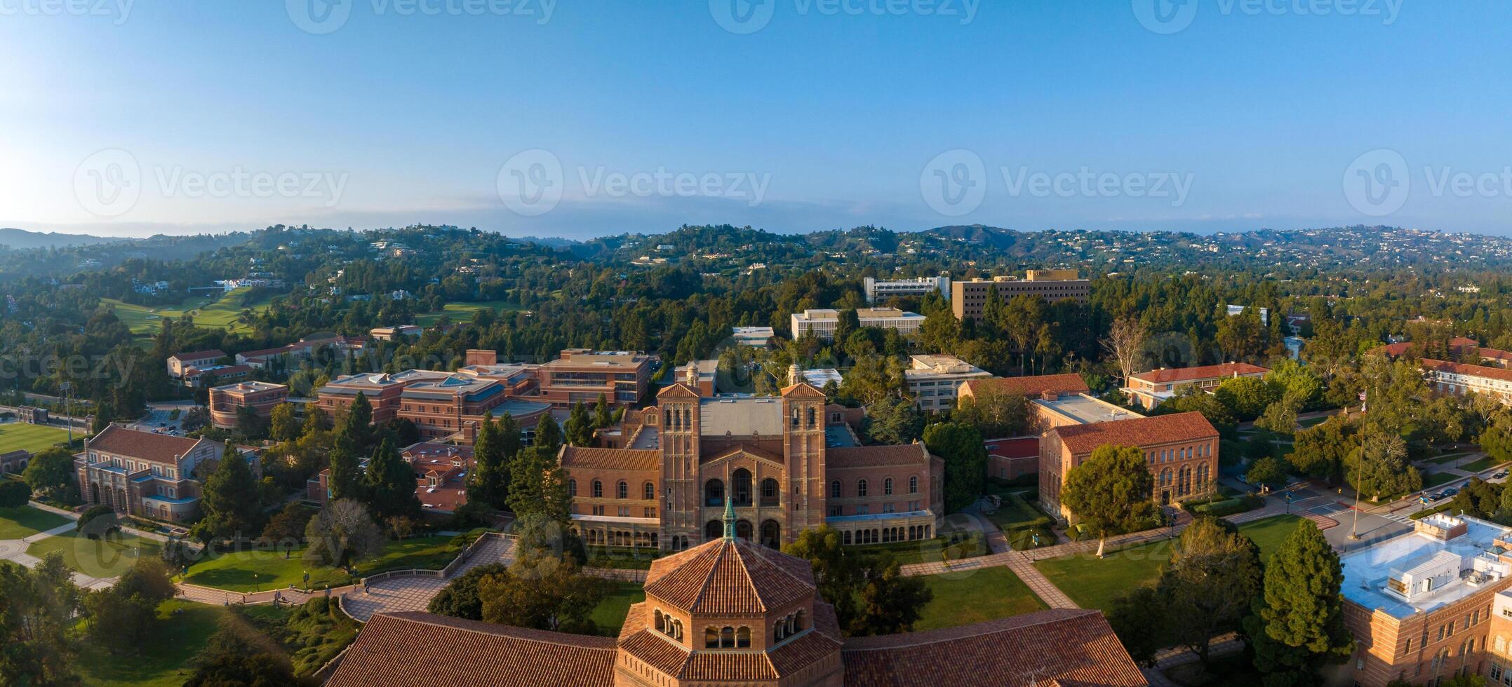 Aerial View of UCLA Campus in Westwood, Los Angeles with Red-Brick Buildings and Lush Greenery on Sunny Day photo