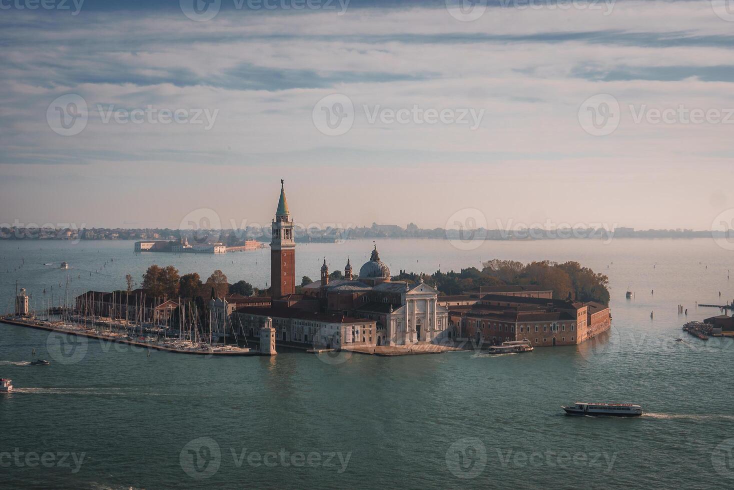 Aerial view of Venice, Italy with boats navigating through canals and surrounded by water. photo