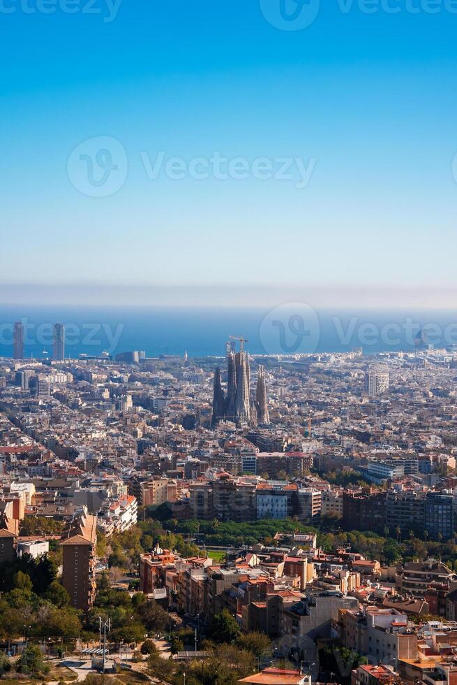 Expansive Panoramic View of Barcelona, Sagrada Familia Against Blue Sky photo