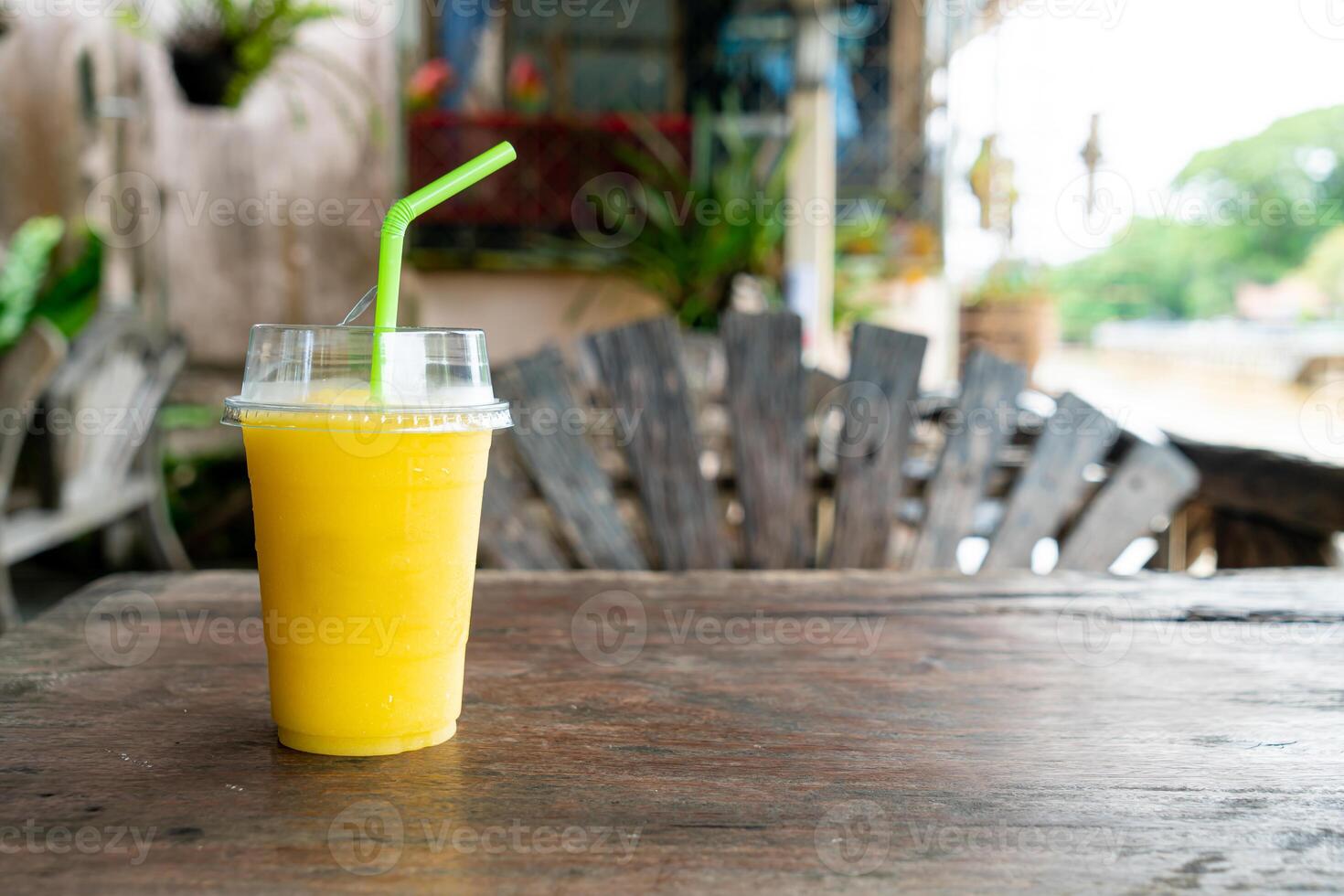 mango smoothies in take away glass photo