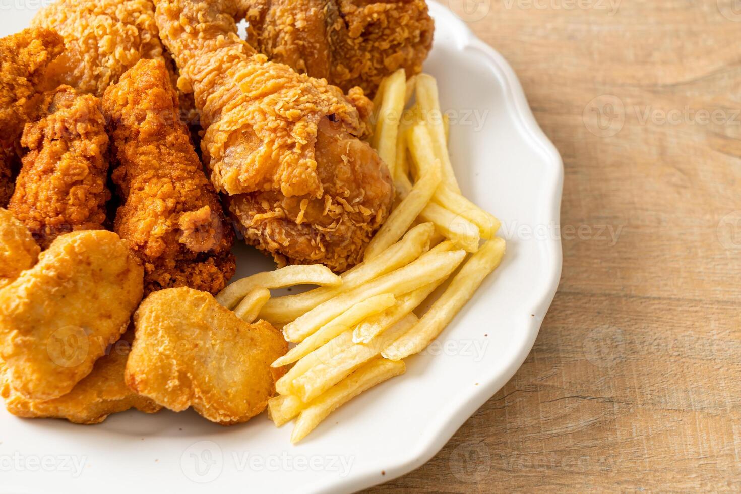 fried chicken with french fries and nuggets on plate photo