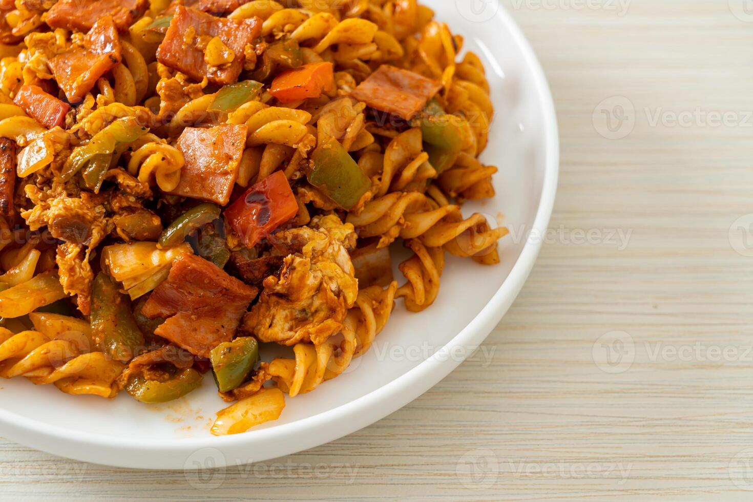 fusilli pasta with ham and tomatoes sauce photo