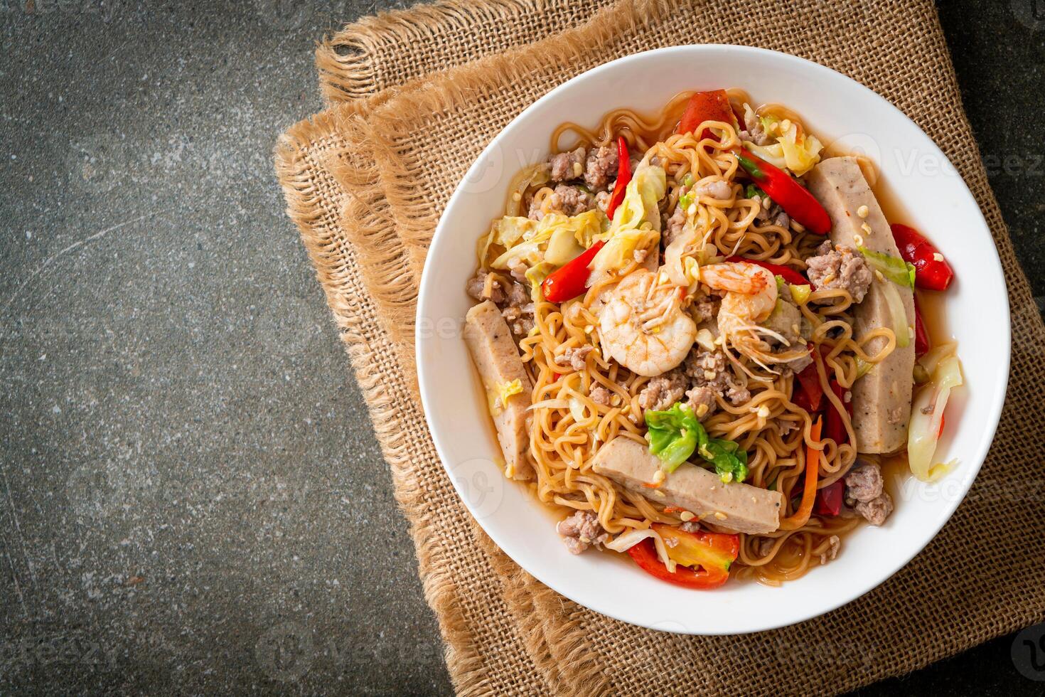 Instant noodles spicy salad on plate photo
