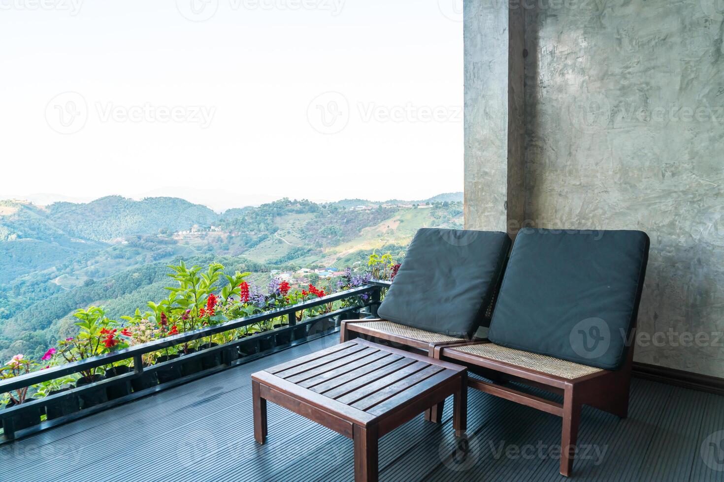 chair on balcony with mountain hill background photo