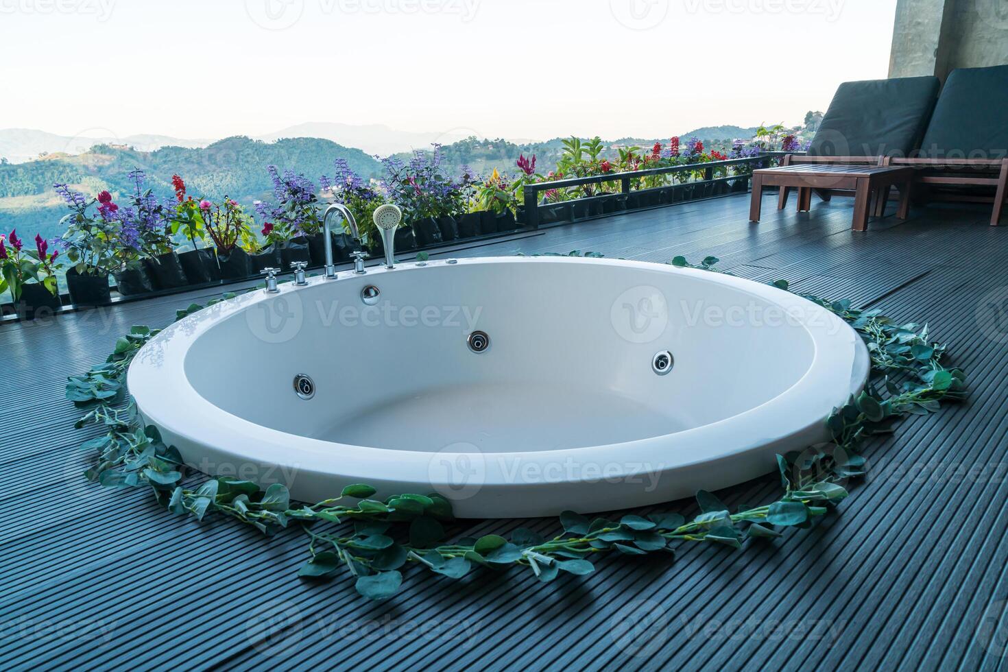 bath tub on balcony with mountain hill background photo