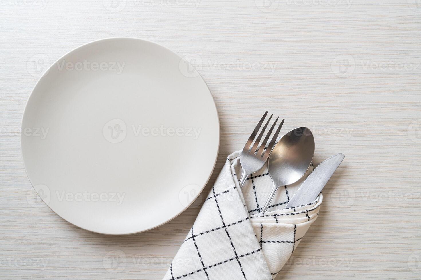 empty plate or dish with knife, fork and spoon photo