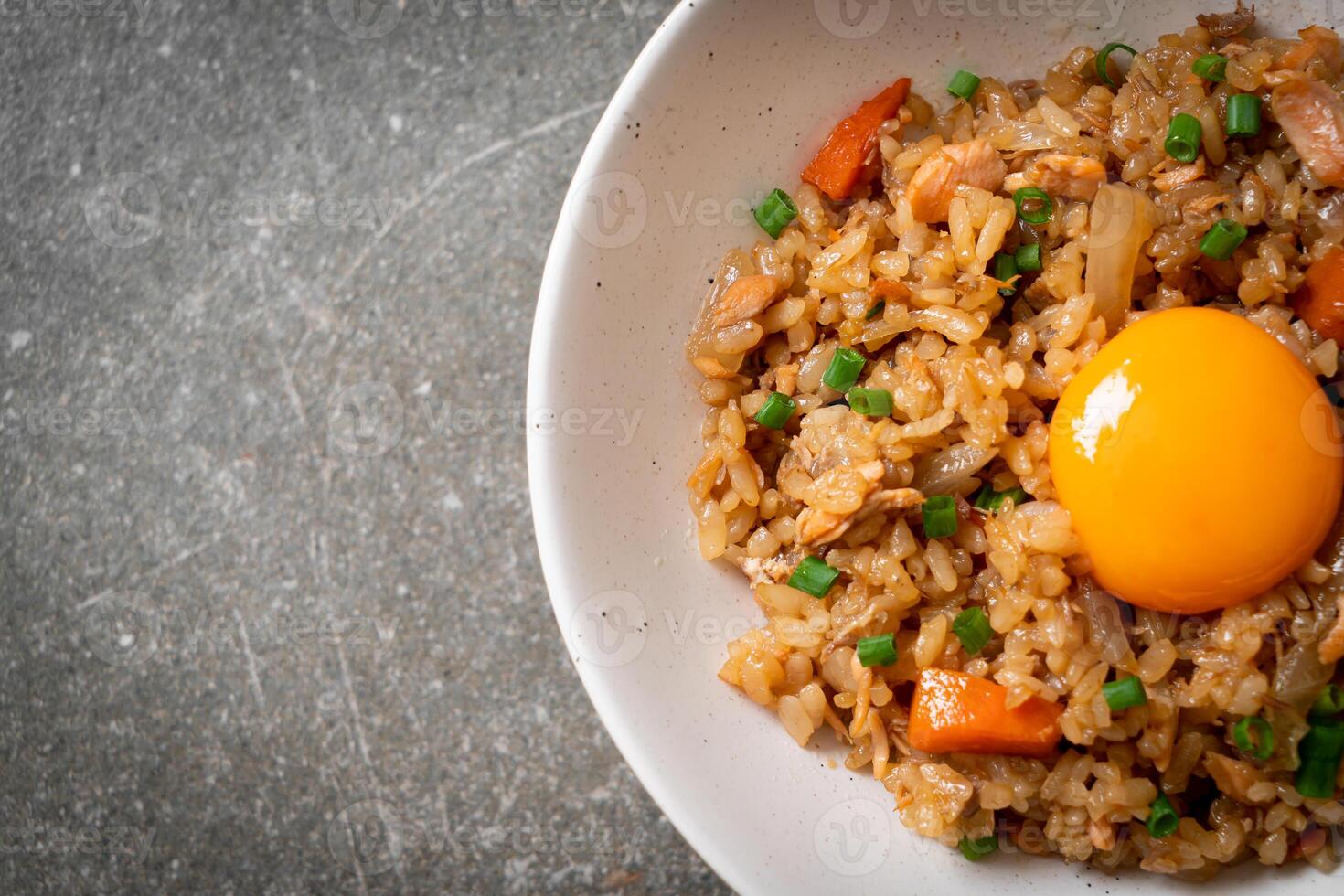 salmon fried rice with pickled egg on top photo