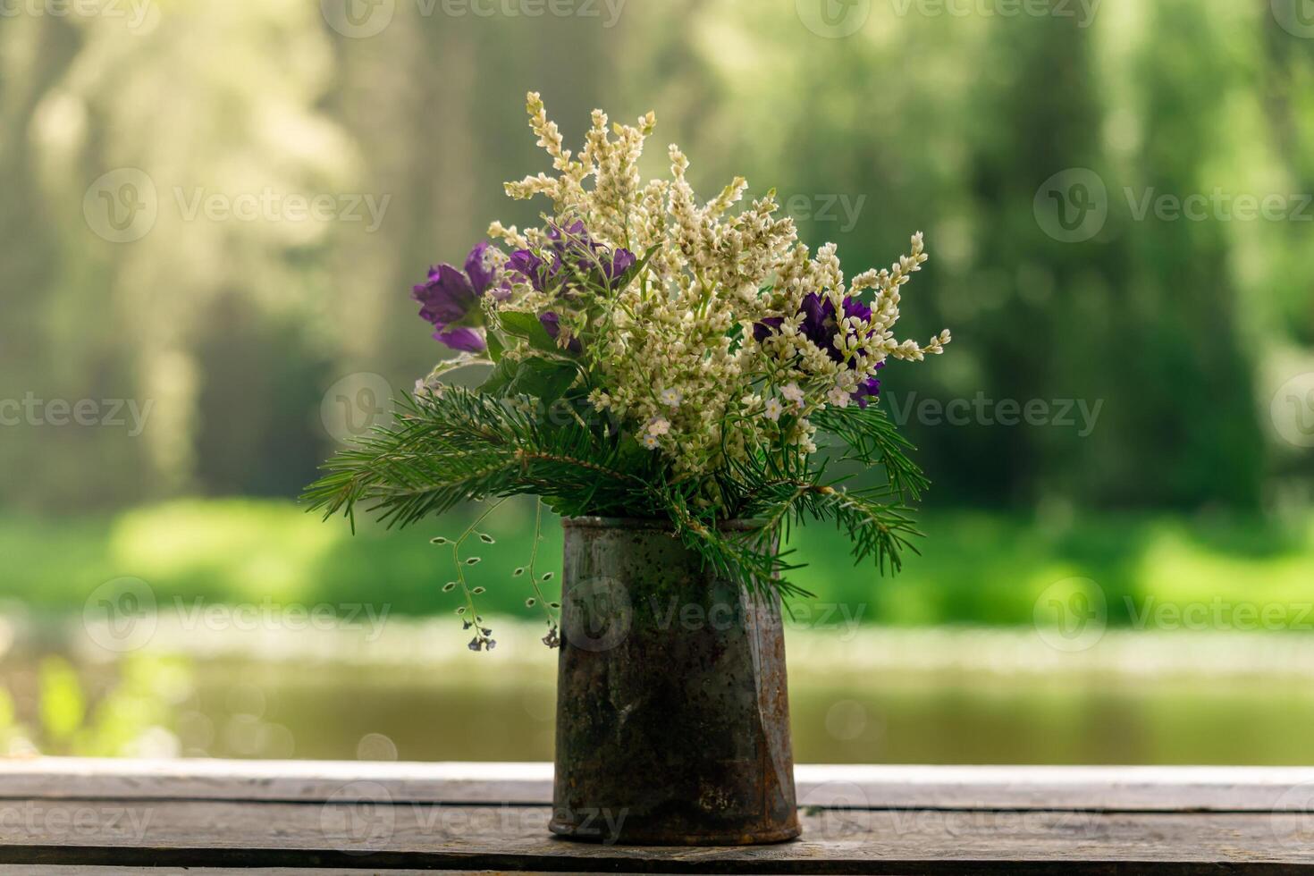 bouquet of wild plants in a rusty tin can photo