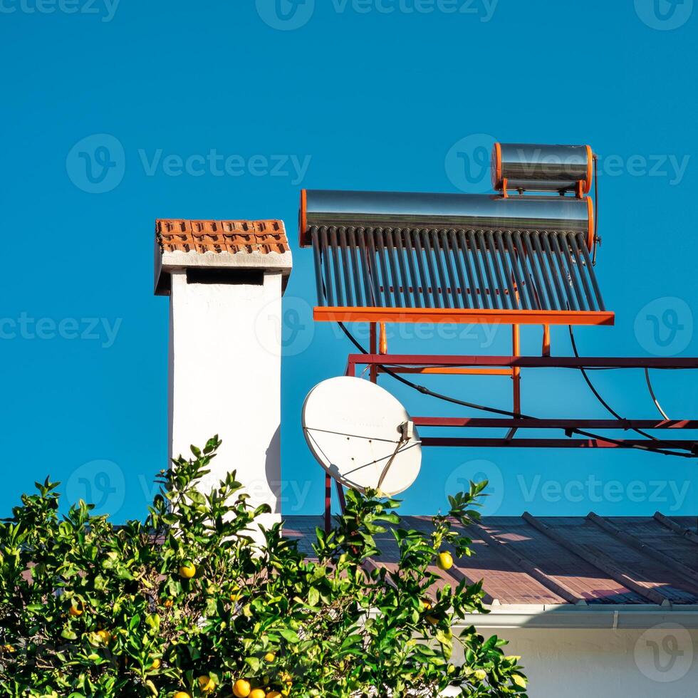 solar thermal water heating collector on the roof of the house photo