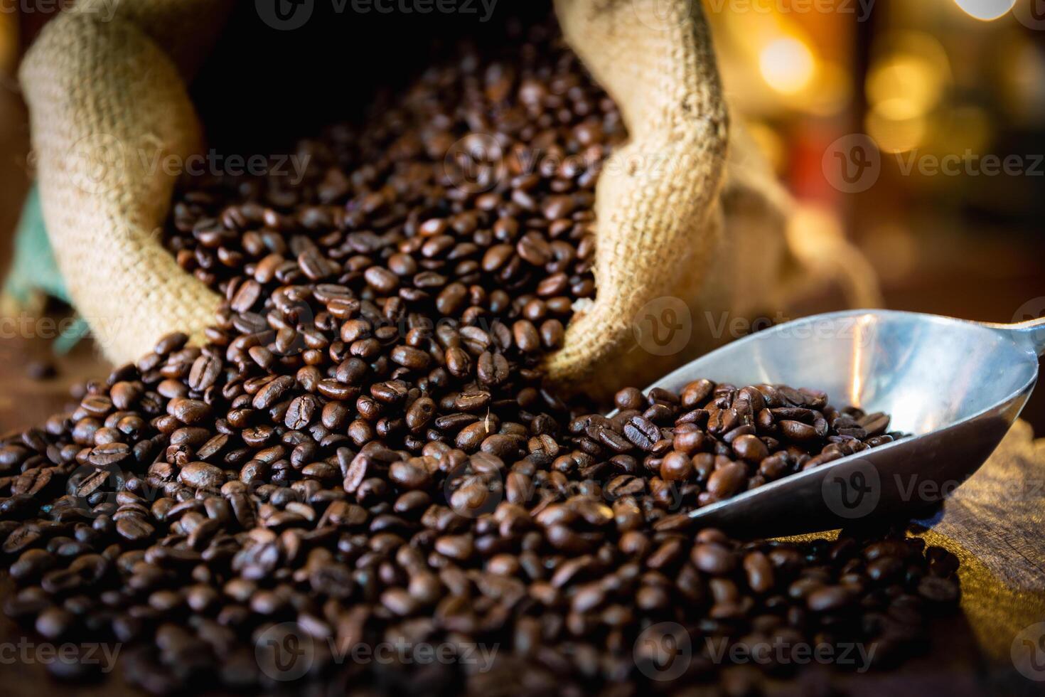 Cup of coffee, bag and scoop on old wooden background, with copy space. photo