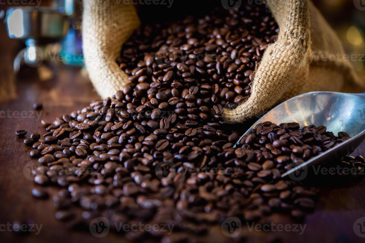 Cup of coffee, bag and scoop on old wooden background, with copy space. photo