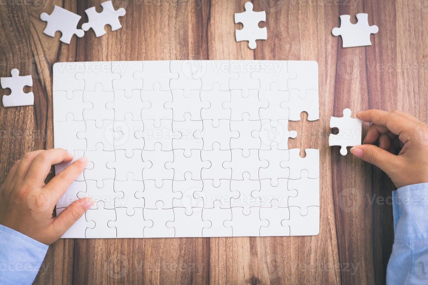 Hand of woman connecting jigsaw puzzle, Business solutions, success and strategy, Business partnership concept. photo