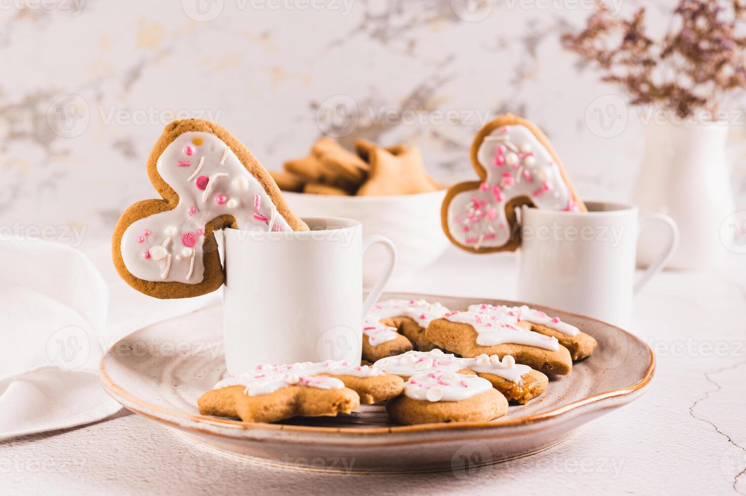 Homemade cookies hugging a coffee mug on a plate on the table photo