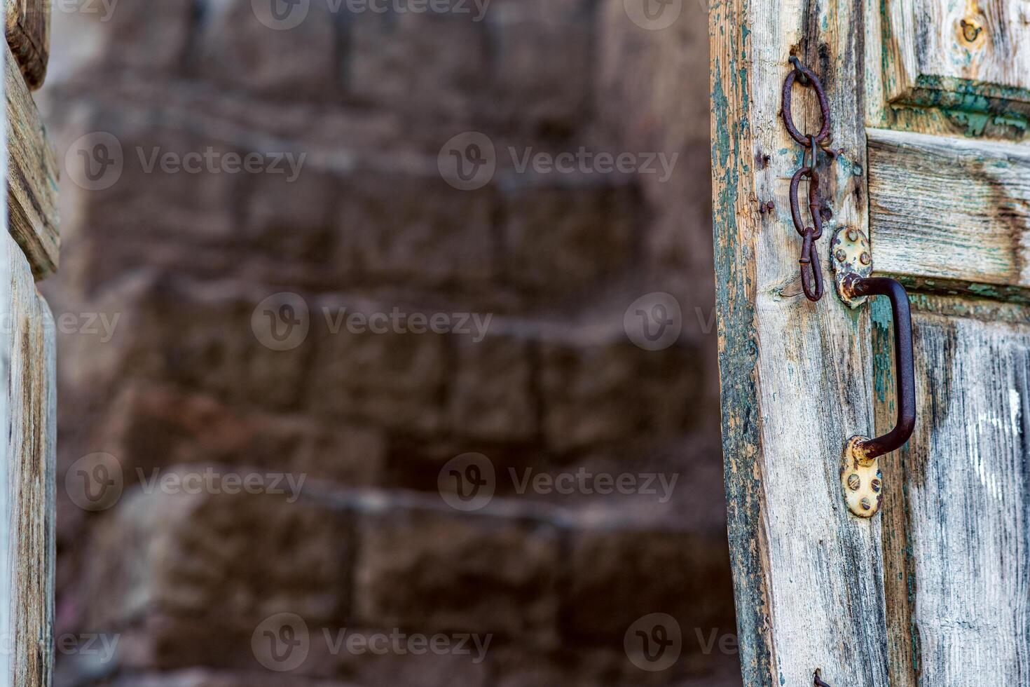 detail of wooden door in the ruins of an abandoned house in the ruins of the ghost village of Gamsutl in Dagestan photo