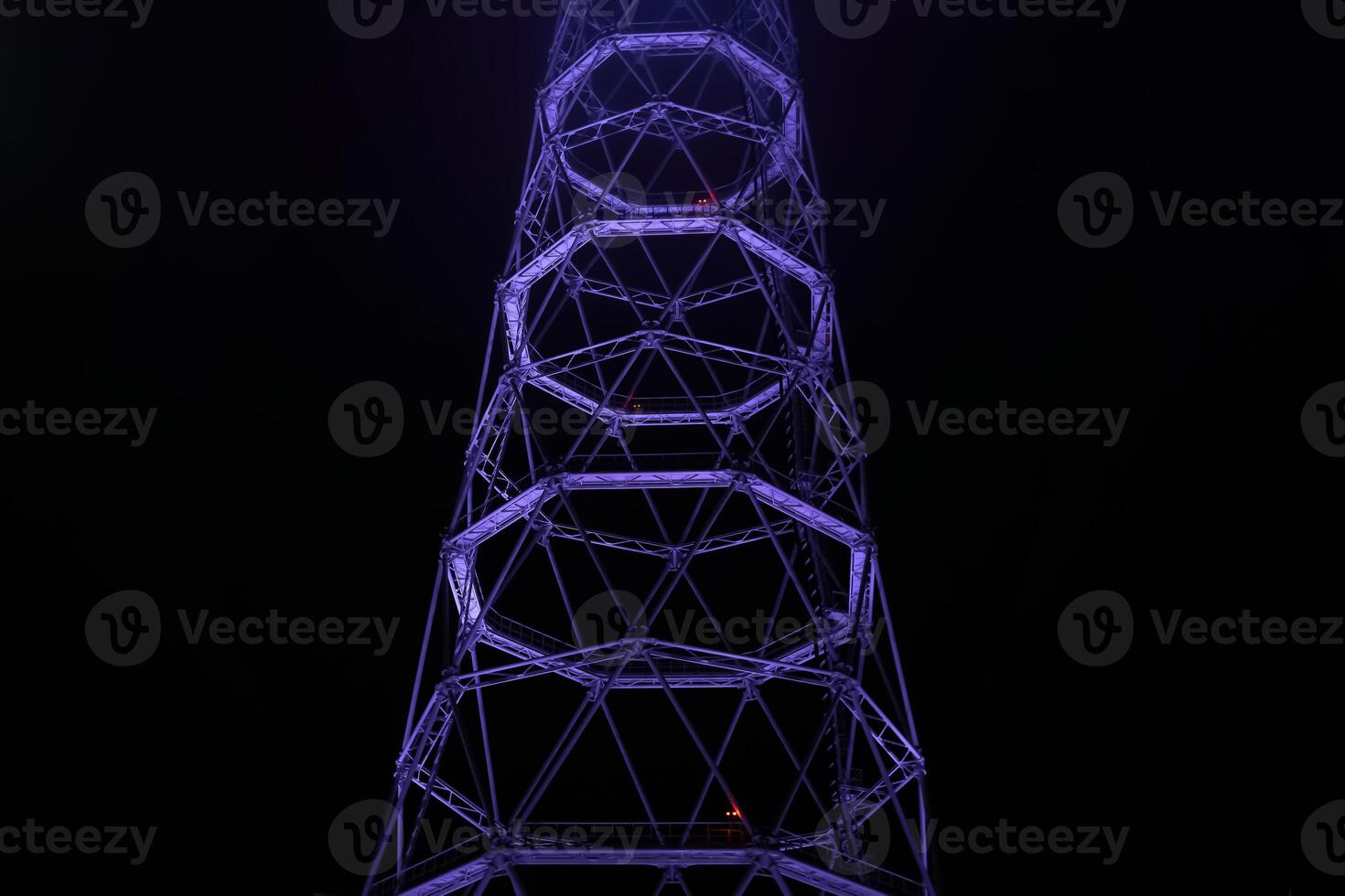 fragment of lattice TV tower against the background of night darkness photo
