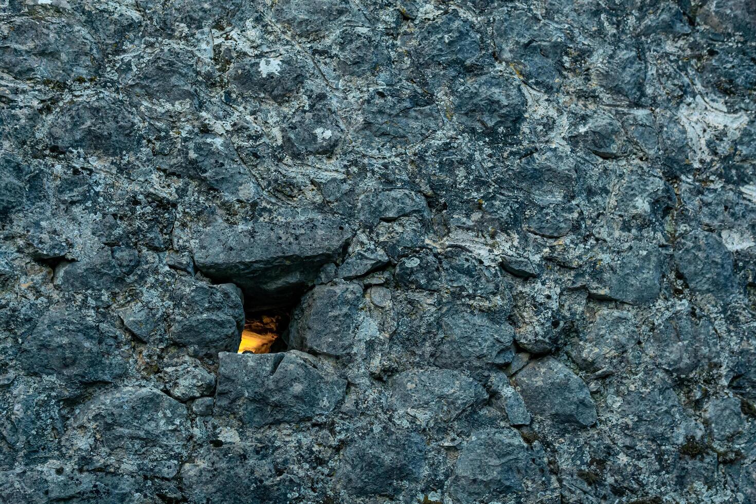 loophole in the old fortress wall through which light breaks photo