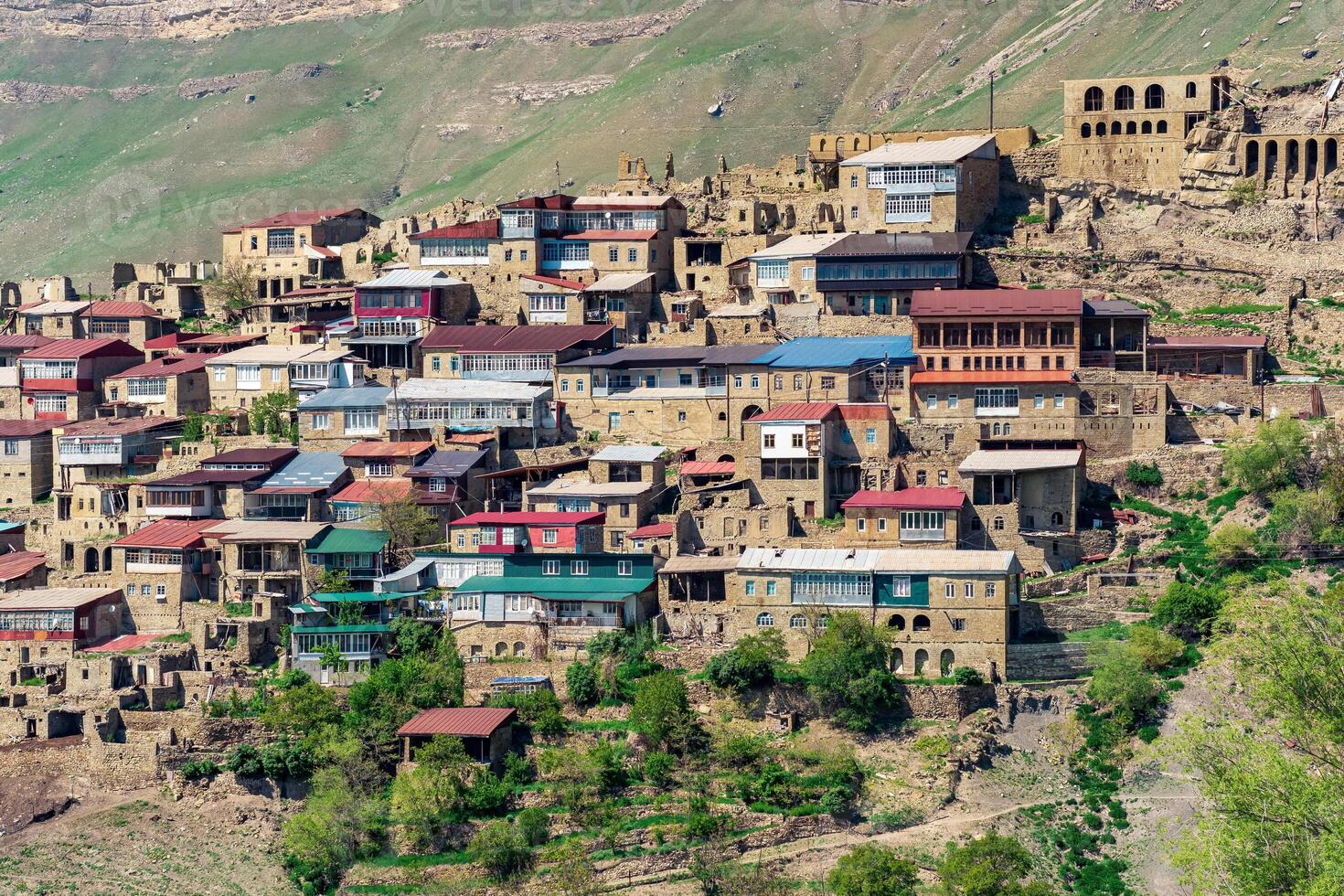 traditional dwellings are located one above the other along the mountain slope in the ancient village of Chokh in Dagestan photo