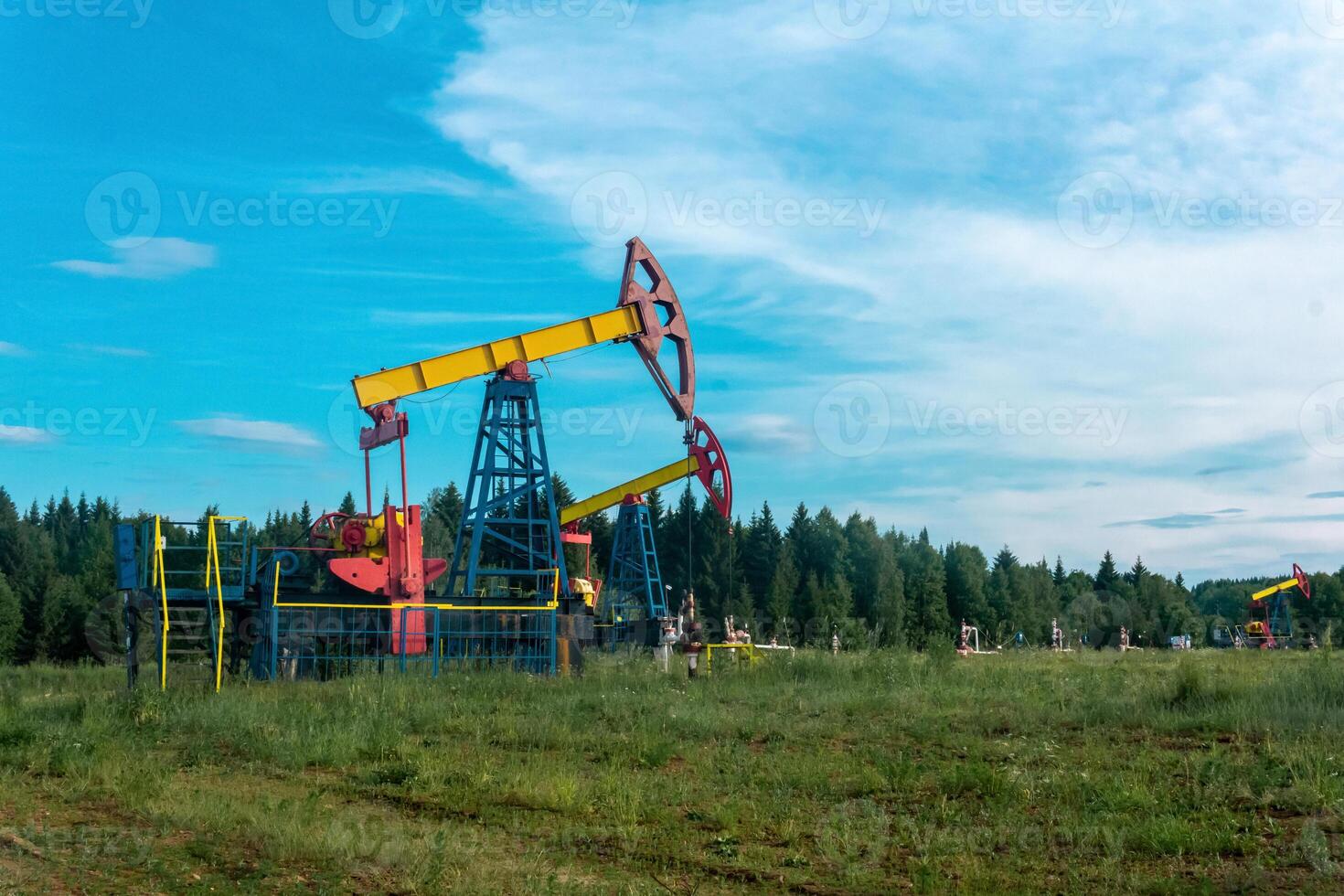 oil pumpjacks in a clearing in the forest photo