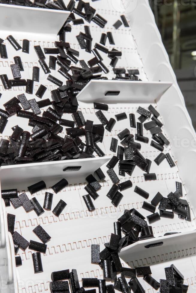 sliced fruit pastilles on the conveyor of a confectionery factory photo